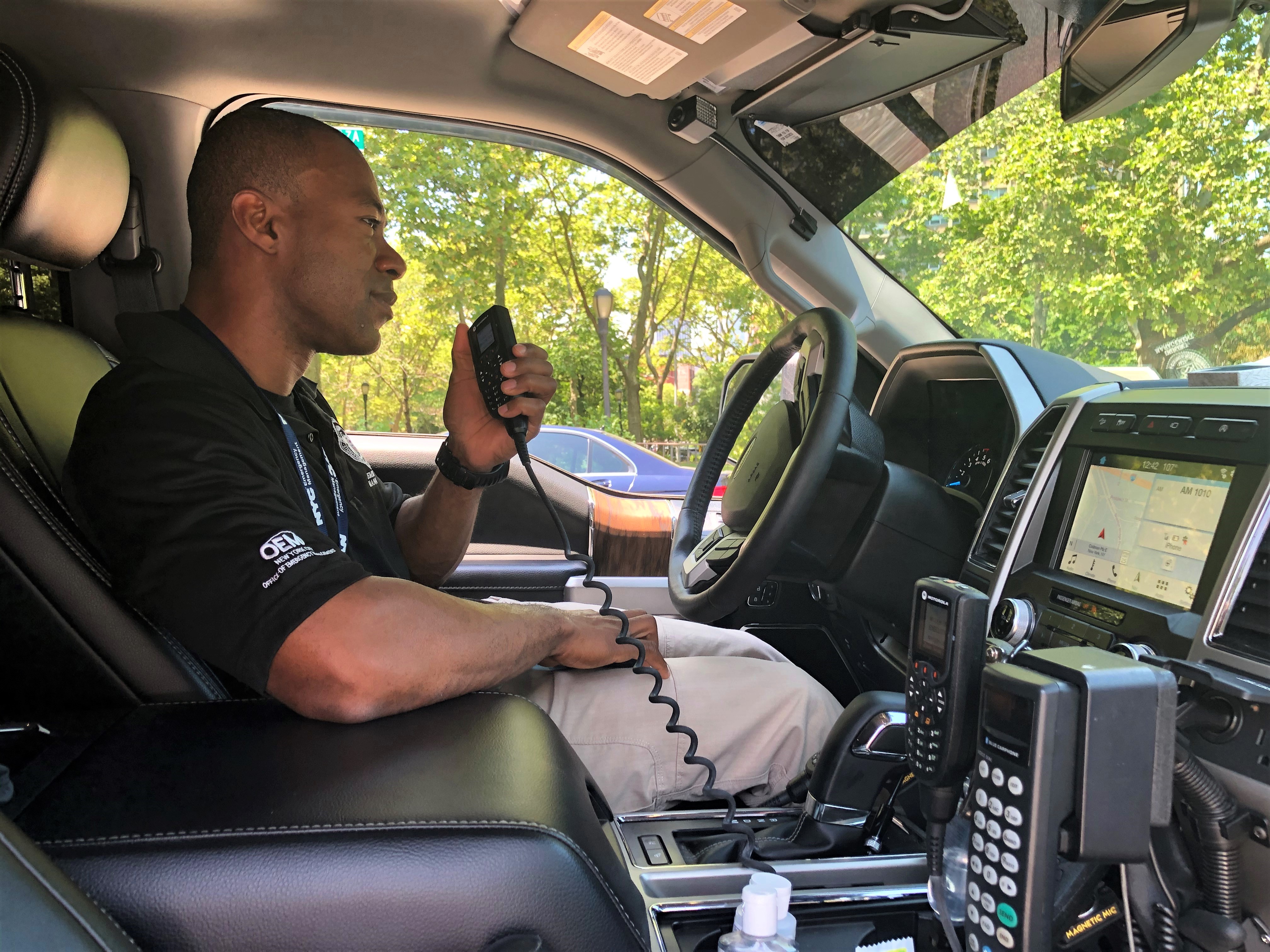CIC McCharles Bouzy recieving a radio call inside his SUV